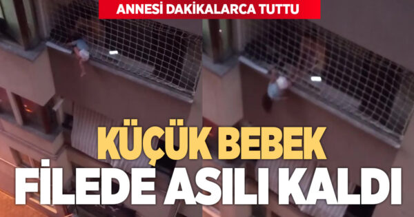 Balkon filesinde asılı kalan çocuğunu düşmesin diye dakikalarca tuttu